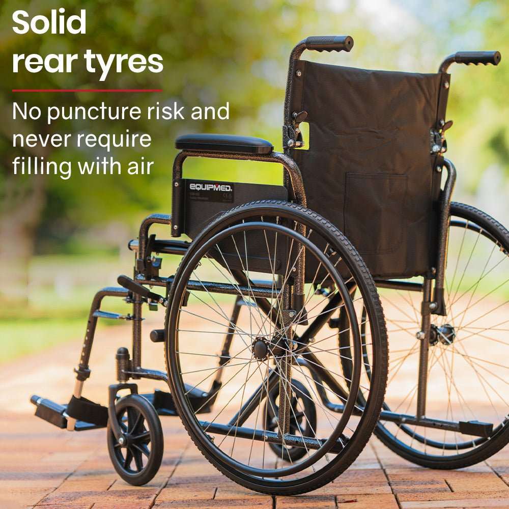 Equipmed 24 inch folding bariatric wheelchair with XL wide seat, dark grey powder-coated steel frame, park brakes, retractable armrests, and solid non-puncture tyres.