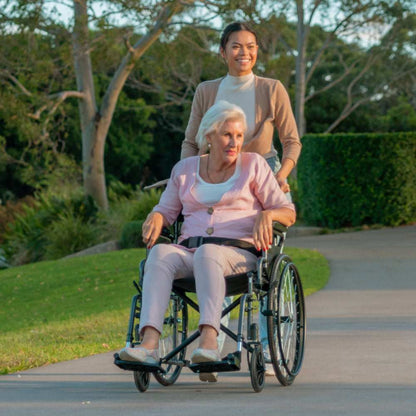 Equipmed 24 inch folding bariatric wheelchair with XL wide seat, dark grey steel frame, retractable armrests, park brakes, and solid non-puncture tires