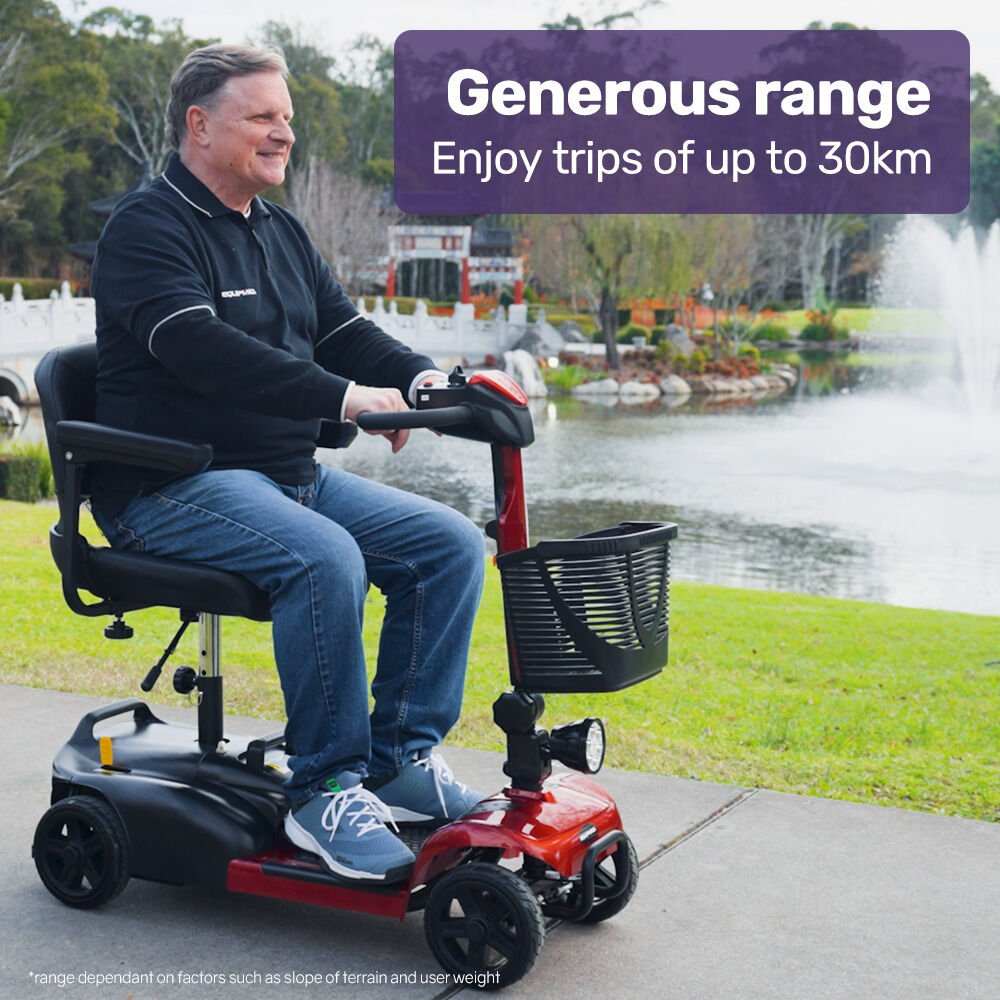 Red EQUIPMED FreeLite+ mid-sized foldable electric mobility scooter with lithium battery and padded seat